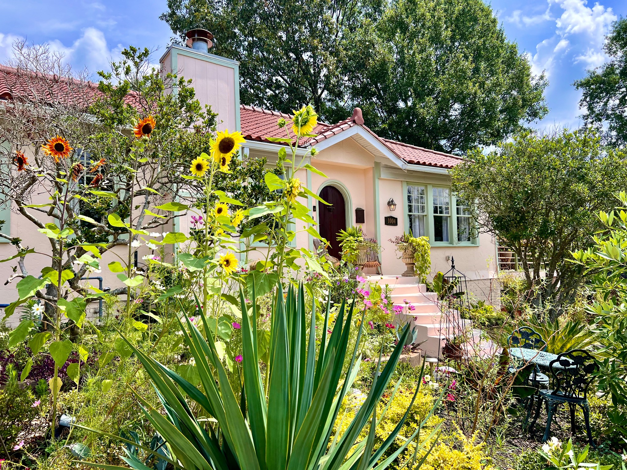 Sunflowers and a lush garden outside a Townsend & Co home